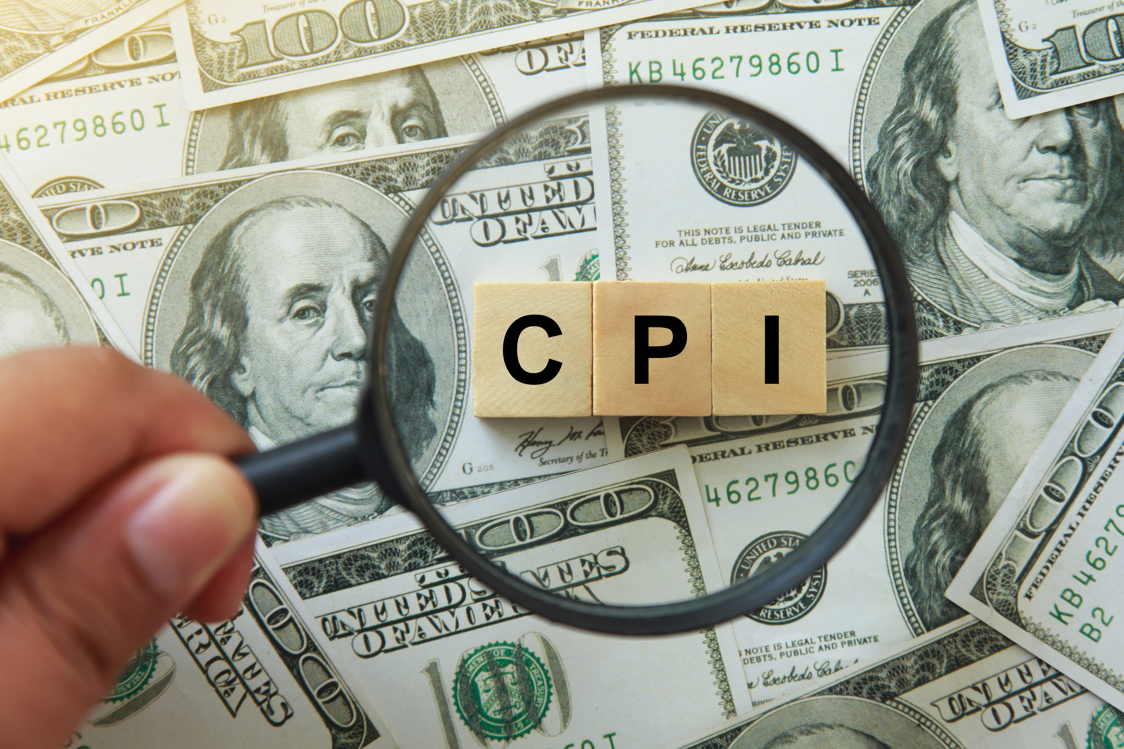 CPI, consumer price index symbol. hand holding magnifying glass