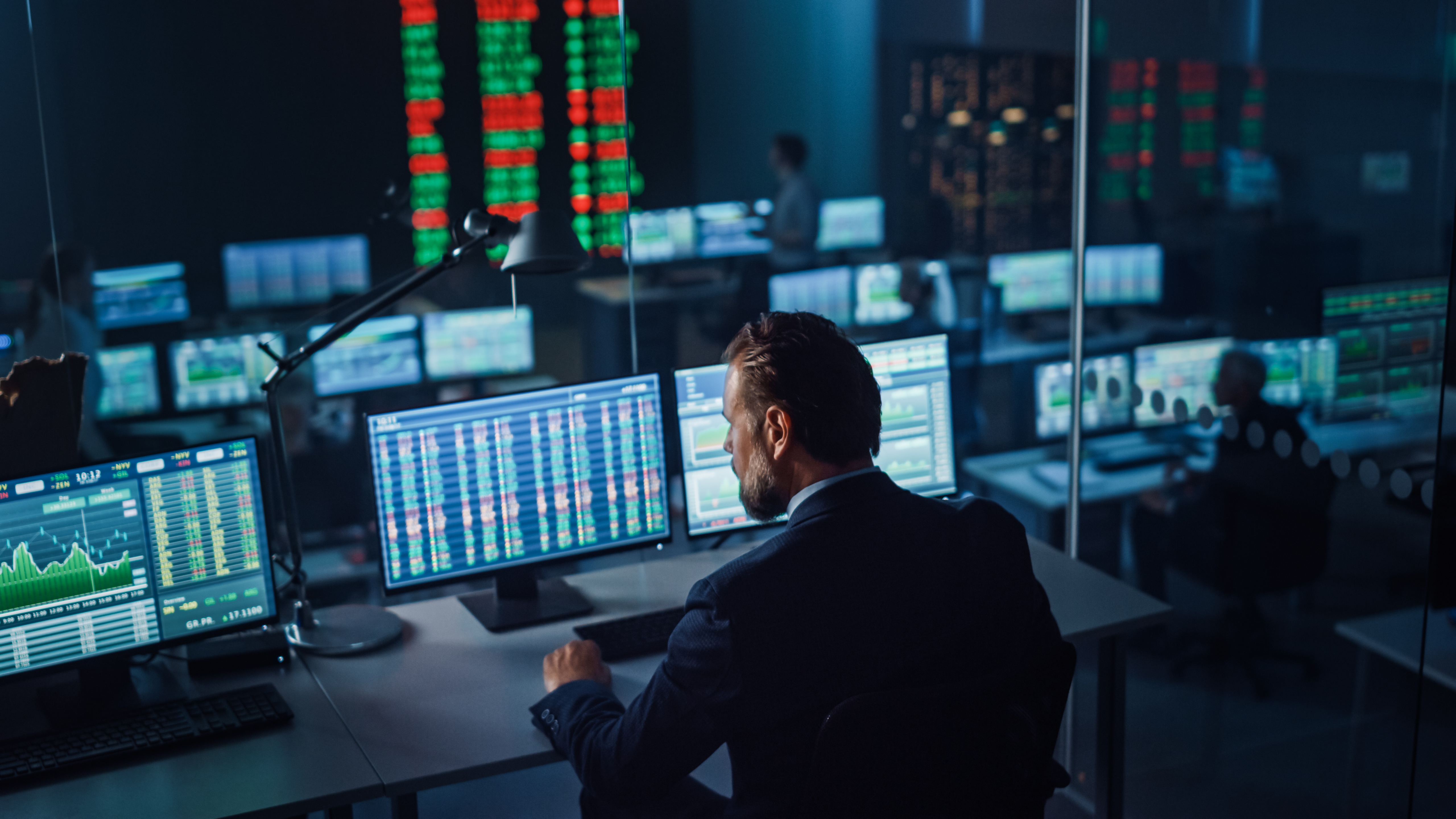 Professional Financial Data Analysts Working in a Modern Monitor