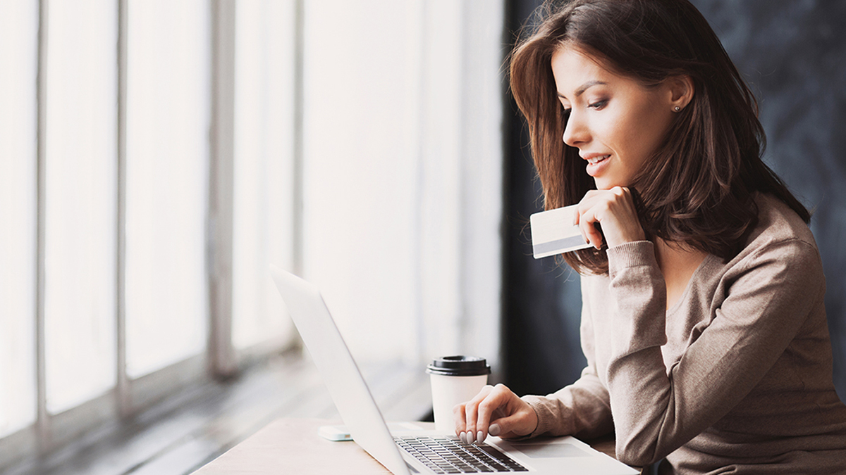 Young,Woman,Holding,Credit,Card,And,Using,Laptop,Computer.,Businesswoman